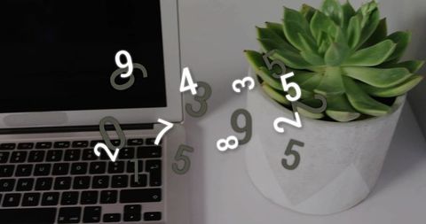 Minimalist workspace featuring geometric succulent planter, laptop keyboard and floating digits