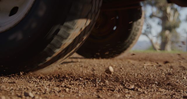 A close-up view of a vehicle's tires on a dirt road, with copy space - Download Free Stock Photos Pikwizard.com