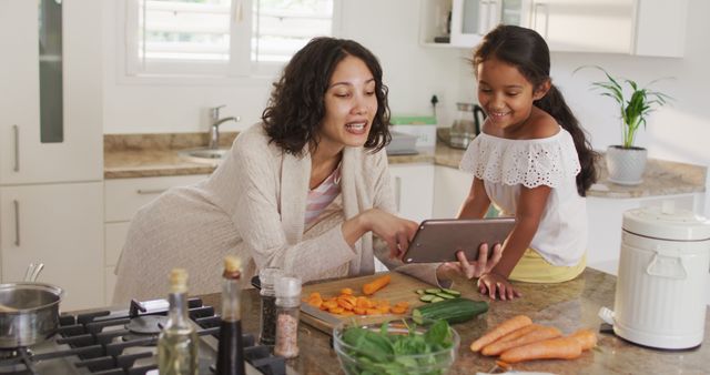 Mother and Daughter Cooking Together Watching Recipe on Tablet - Download Free Stock Images Pikwizard.com