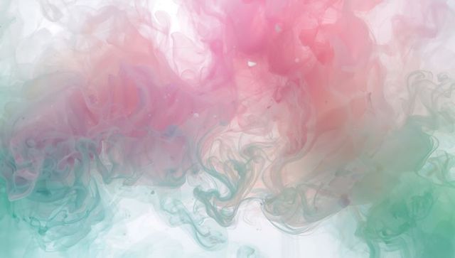 Pastel pink and teal ink swirling and drifting in liquid, ethereal abstract background