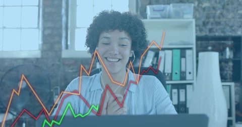 Biracial Businesswoman Analyzing Charts on Laptop in Office