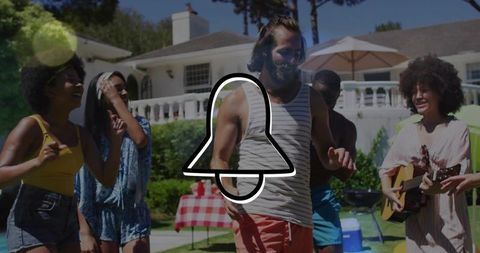 Friends enjoying backyard summer party dancing, playing guitar, and barbecuing