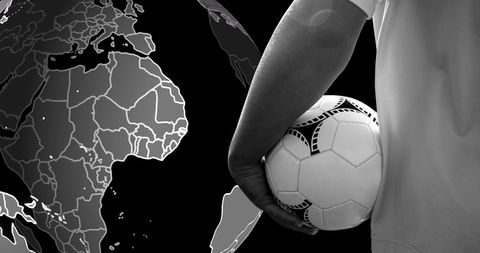 Soccer player holding ball with spinning globe in background
