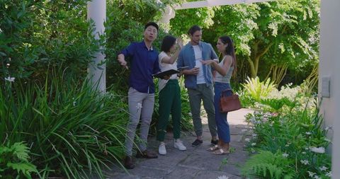 Planning Outdoor Event in Lush Garden with Friends