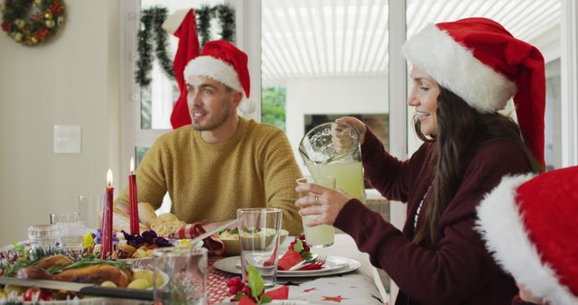 Happy Friends Celebrating Christmas Dinner, Wearing Santa Hats - Download Free Stock Images Pikwizard.com