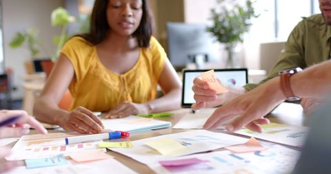 Creative Team Collaborating in Office with Notes and Tablet