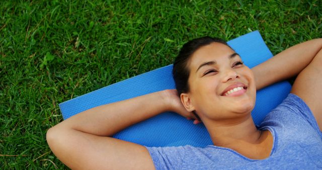 Relaxed Woman Lying on Yoga Mat Outdoors - Download Free Stock Images Pikwizard.com