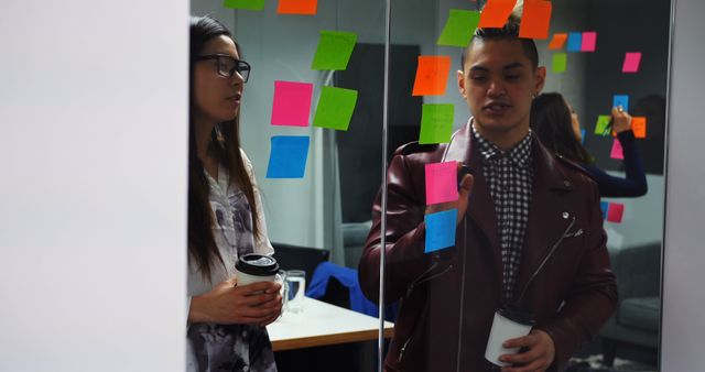 Colleagues Brainstorming with Sticky Notes in Modern Office - Download Free Stock Images Pikwizard.com