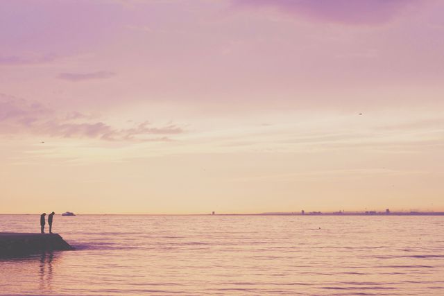2 Person Standing on Shore Near Calm Sea - Download Free Stock Photos Pikwizard.com