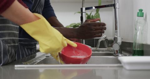 Diverse Couple Washing Dishes Together in Kitchen - Download Free Stock Images Pikwizard.com