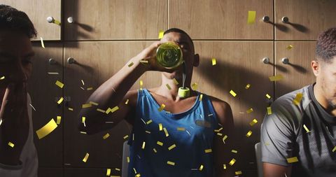 Athlete Hydrates in Locker Room Amid Celebratory Confetti