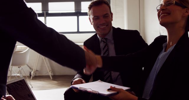 Businesspeople Handshaking During Meeting in Modern Office - Download Free Stock Images Pikwizard.com