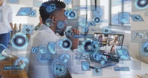 Business professional using laptop with futuristic holographic interface