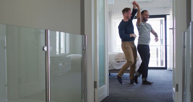 Happy couple dancing together in modern apartment hallway - Download Free Stock Images Pikwizard.com