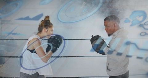 Boxer sparring with coach holding mitts in ring with augmented hud training overlay