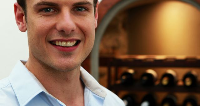 Smiling Man Inside Wine Cellar, Shelves of Bottled Wine in Background - Download Free Stock Images Pikwizard.com