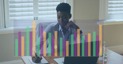 Businesswoman Analyzing Charts and Data at Office Desk