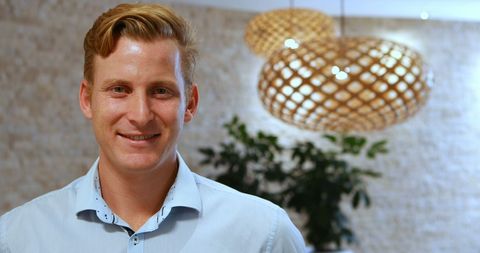 Confident Young Caucasian Businessman in Modern Office Environment