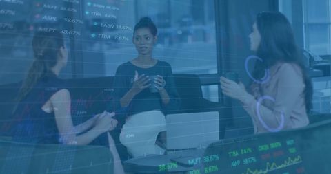 Diverse Businesswomen Discussing in Modern Office with Digital Data Overlay