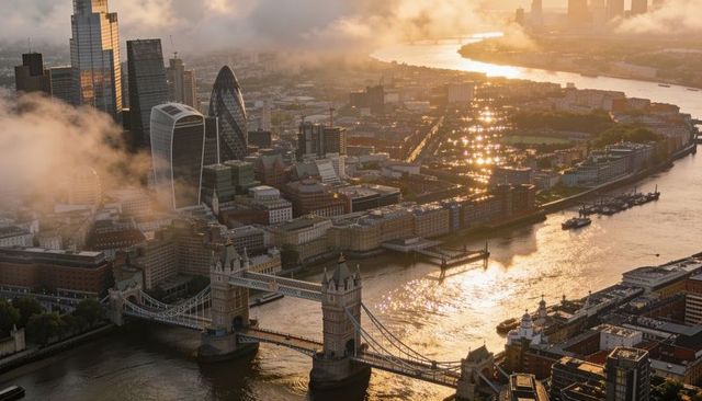 Aerial golden hour view tower bridge river thames london skyline sunlit reflections