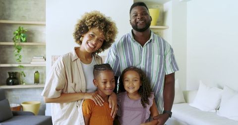 Smiling Family Posing in Cozy Living Room Setting