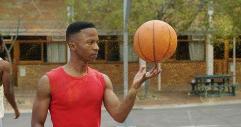 Athlete balancing basketball on finger outdoors