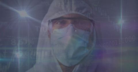 Caucasian doctor in protective gear analyzing data during pandemic