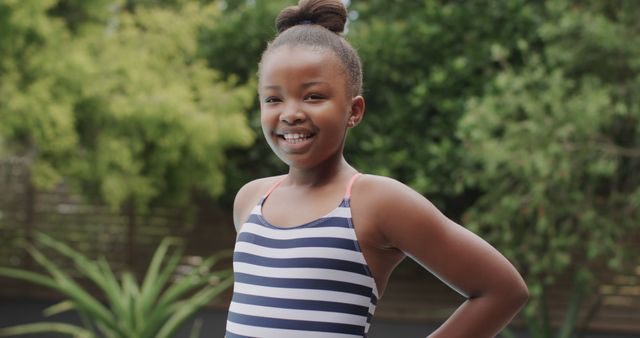 Smiling Girl in Striped Swimsuit Outdoors - Download Free Stock Images Pikwizard.com