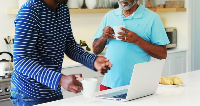 Two Men Having Coffee and Working on Laptop in Modern Kitchen - Download Free Stock Images Pikwizard.com