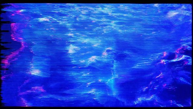 Glowing crt monitor displaying neon blue-violet waves with scanlines and glitch noise