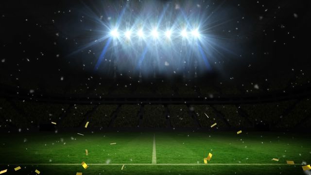 Golden confetti is falling onto an empty football field under bright, illuminated floodlights, creating a festive and celebratory atmosphere. This video is ideal for use in promotions and advertisements highlighting sporting events, tournaments, and victory celebrations. It can also be used to create motivational and inspirational sports-themed content.