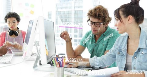 Coworkers Collaborating in Modern Technology Office