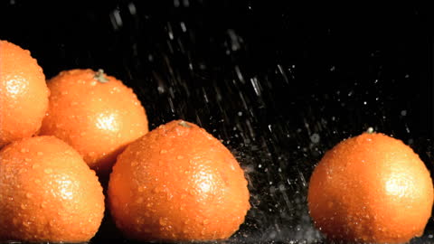 Fresh Oranges Splashing Under Water Droplets