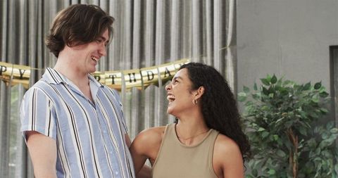 Happy Couple Preparing Birthday Party with Decor in Living Room