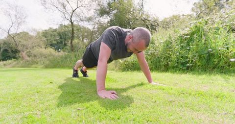 Man Exercising with Push-Ups in Sunny Park