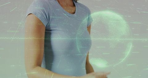 Woman gesturing toward augmented reality green data globe hologram with analytics overlay