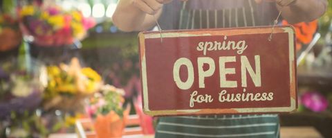 Spring Sign Announcing Business Reopening in Floral Background