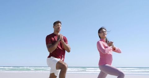 Asian Woman and Man Lunging on Sunny Beach for Outdoor Fitness and Cardio Training