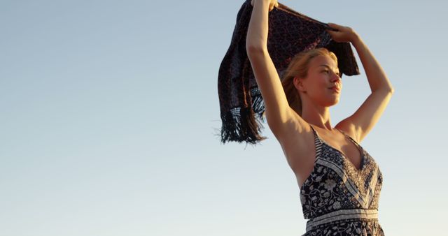 Smiling Woman Enjoying Evening Breeze with Scarf at Beach - Download Free Stock Images Pikwizard.com