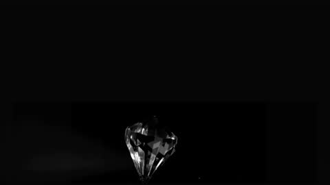 Glistening Spinning Diamond on Black Background in Slow Motion