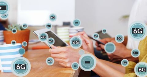 Coworkers Utilizing Digital Devices with Futuristic 6G Symbols