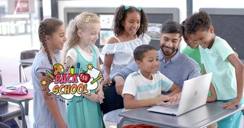Smiling teacher guiding diverse students using laptop during back to school tech lesson