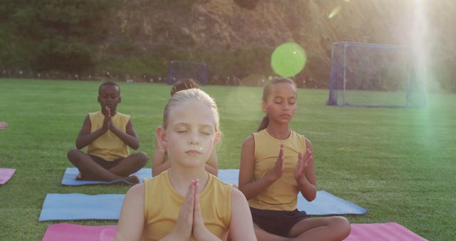 Diverse group of children practicing yoga outdoors at sunset - Download Free Stock Images Pikwizard.com