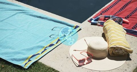 Relaxing poolside with straw hat, pink sunglasses, snorkel and striped towels vacation essentials