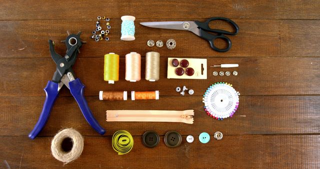 Various sewing tools and accessories are neatly arranged on a wooden surface, with copy space - Download Free Stock Photos Pikwizard.com
