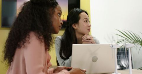 Diverse professionals discussing sustainable energy innovations