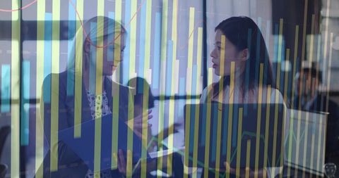 Businesswomen Discussing Data with Graph and Technology