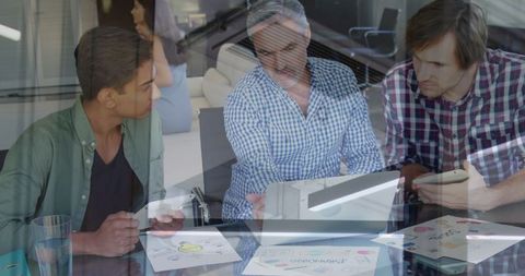 Creative Team Analyzing Design Concepts in Office Meeting