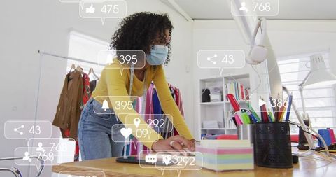 Fashion designer using tape measure in creative studio workspace