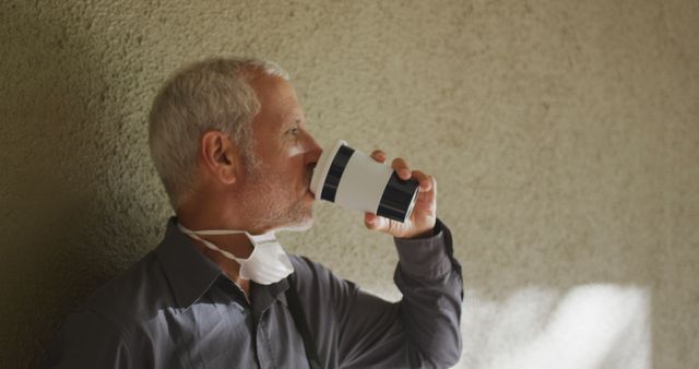 Senior Man Relaxing with Coffee and Mask Off During Break - Download Free Stock Images Pikwizard.com